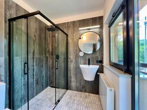 a bathroom with a shower and a sink at Greg Rooms in Sinaia