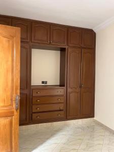 a large wooden cabinet with a television in a room at 3 Chaaban 1, 1136 in Larache