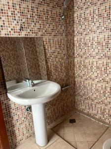 a bathroom with a sink and a mirror at 3 Chaaban 1, 1136 in Larache