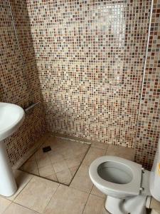 a bathroom with a toilet and a sink at 3 Chaaban 1, 1136 in Larache