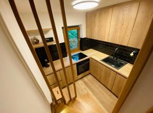 a small kitchen with wooden cabinets and a sink at Chalet Jasmin in Bohinj