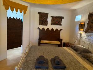 a bedroom with a bed with two pairs of shoes on it at Case d'Artista in Savelletri di Fasano