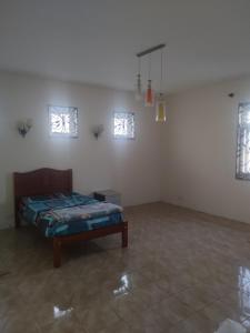 a room with a bed and two windows at Bamboo guest house in Quatre Bornes +3 photos