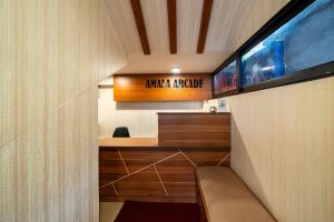 a room with a desk and a sign on a wall at Amala Arcade AC Rooms in Trichūr