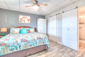 une chambre avec un lit et un ventilateur de plafond dans l'établissement Tropic Terrace #35 - Beachfront Resort, à St. Pete Beach