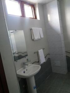 a bathroom with a sink and a mirror at Гостевой дом Barakat in Samarkand