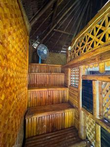 an inside view of a wooden sauna with a fan at Alta-Cabana in El Nido