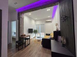 a living room with a couch and a table at Lyda Apartment in Alexandroupoli