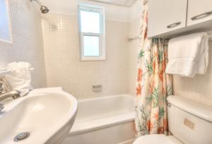 a white bathroom with a tub and a sink at Tropic Terrace Suite #24 - Beachfront Resort in St Pete Beach +17 photos