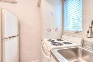 a kitchen with a stove and a sink at Tropic Terrace Suite #3 - Beachfront Resort in St Pete Beach +15 photos
