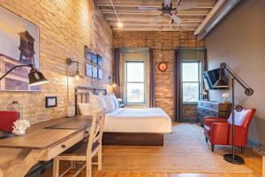 a bedroom with a bed and a desk in a room at Hip Urban Loft - Small Town Charm - 124 LOFTS #4 in West Dundee