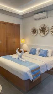 a bedroom with two beds with swans on them at Bohemian Private pool Villa - Fulton Casablanca in Beran-kidul