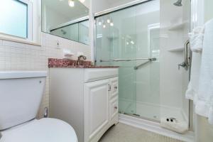 a bathroom with a shower and a toilet and a sink at Tropic Terrace Suite #44 - Beachfront Resort in St Pete Beach +19 photos