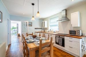 a kitchen and dining room with a table and chairs at Ingham - Accessible Bungalow in Newlyn