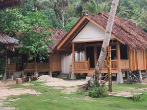 a small house with a thatched roof at Lances surf camp in Katiet +31 photos