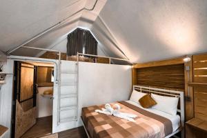 a bedroom with a bunk bed with a ladder at Chiewlan Camp and Resort in Ban Pha Saeng Lang