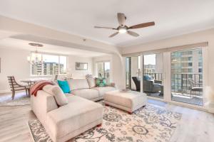 a living room with a couch and a ceiling fan at Sand Key South Beach Condo 601 in Clearwater Beach