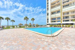 a swimming pool in front of a building at Sand Key South Beach Condo 601 in Clearwater Beach