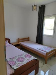 a bedroom with two beds and a window at Apartmani Srdanovic in Tivat +55 photos