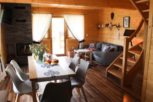 a living room with a table and chairs and a couch at Chałupka pod Brzyzkiem in Ząb