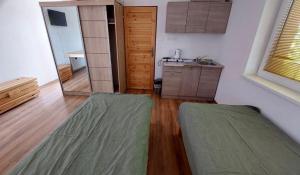 a living room with wooden floors and a mirror at Penzion Baffi in Topoľníky
