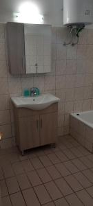a bathroom with a sink and a mirror and a tub at Coastal Dream Apartments in Keramoti +46 photos
