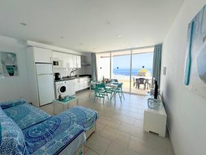 a room with a bed and a kitchen with a view of the ocean at Arthouse Sea View - Acquamarina e Zaffiro in Puerto del Carmen
