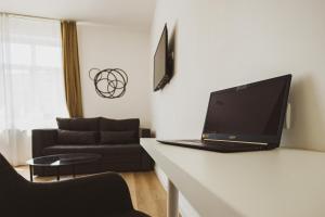 a laptop computer sitting on a counter in a living room at BG Exclusive Suites in Belgrade
