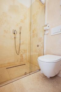a bathroom with a toilet and a glass shower at BG Exclusive Suites in Belgrade