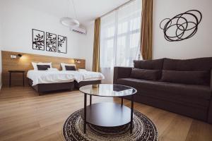 a living room with a couch and a bed at BG Exclusive Suites in Belgrade