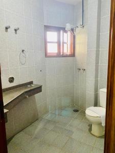 a bathroom with a toilet and a window at Maresias Praia Hotel in Maresias +48 photos