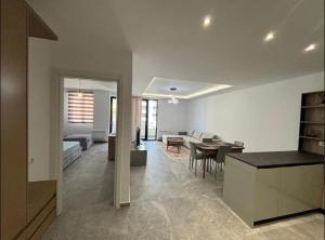 a living room with a kitchen and a dining room at Dioneida Apartments in Sarandë +18 photos