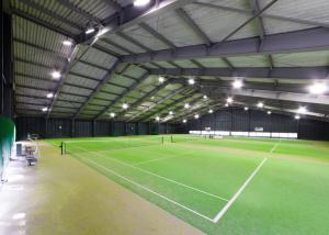a tennis court in a building with two tennis courts at Fuji Premium Resort in Fujikawaguchiko
