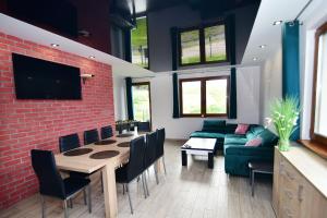 a living room with a table and a couch at Double House MAGI in Kowary