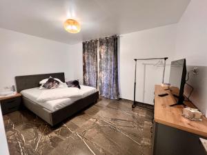 a bedroom with a bed with a dog laying on it at Casa Ilinca in Dărmăneşti