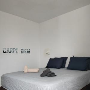 a bedroom with a large bed with blue pillows at Wind House in Costa de Antigua +36 photos