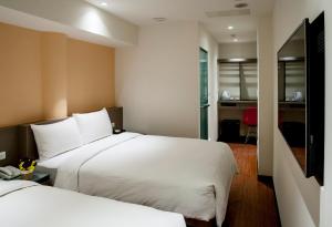 Llit o llits en una habitació de 橙柊棧 CZ Inn