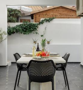 a table with a bowl of fruit on it at Historical Old Town Luxury Apartment in Ierápetra