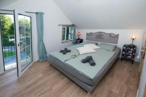 a bedroom with a bed and a large window at L'Echo des Bois in Lyons-la-Forêt +34 photos