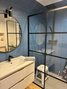 a bathroom with a sink and a mirror at Zalotna Mewa Gąski in Gąski +50 photos