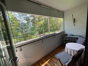 a room with a large window and a table and chair at Spacious Two Room Apartment in Espoo in Espoo
