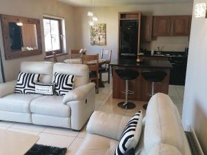 a living room with two couches and a kitchen at The Brooks in Newcastle