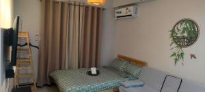 a living room with a couch and a bed and a ladder at Idanna Staycation in Lapu Lapu City