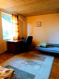 a bedroom with a bed and a desk and a window at 109m2 -Apartment Luiza 1- NEW Cottage in Klaipėda