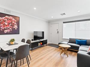 a living room with a couch and a table at Payneham South Paradise Suite 4 in Norwood