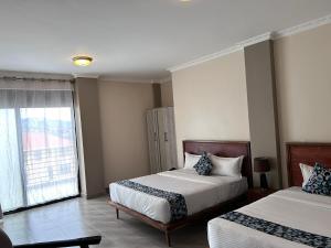 Postel nebo postele na pokoji v ubytování Starview Hotel Kampala