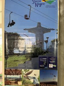 a poster of the statue of christ the redeemer at Apartamento Fontana di Trevi Centro Serra Negra in Serra Negra