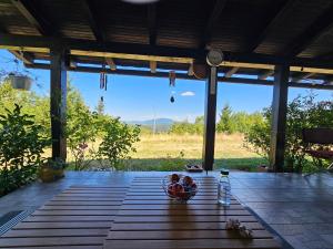 a bowl of fruit on a table on a patio at Holiday Home Modruš in Modruš