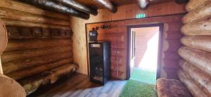 an empty room with a door in a log cabin at Cabana dintre Salcami in Durau
