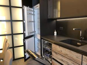 a kitchen with a sink and a dishwasher at CASA LUMIRA Luxury apartment ski-in ski-out in Breuil-Cervinia +29 photos